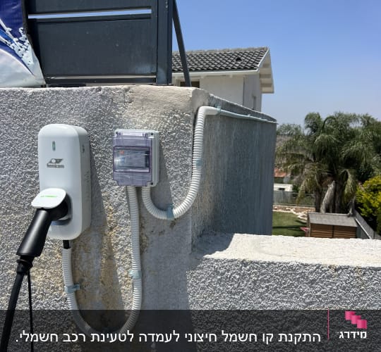 מטען לרכב חשמלי מותקן על קיר עם כבלים